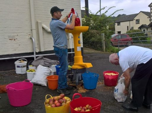 two men apple pressing