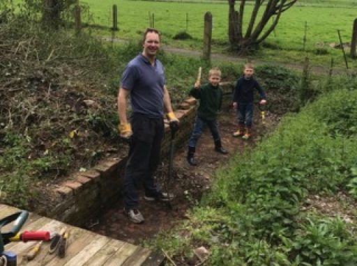 man and two children volunteering