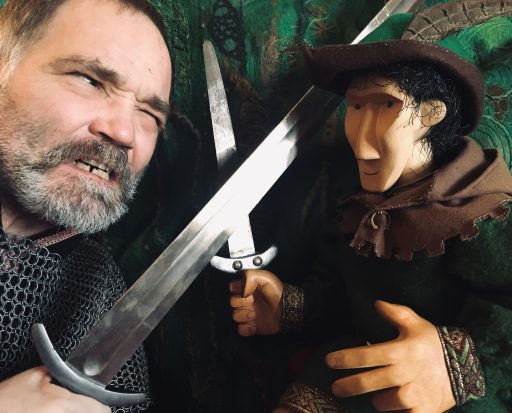 An actor and puppet with swords from the Stockand fair