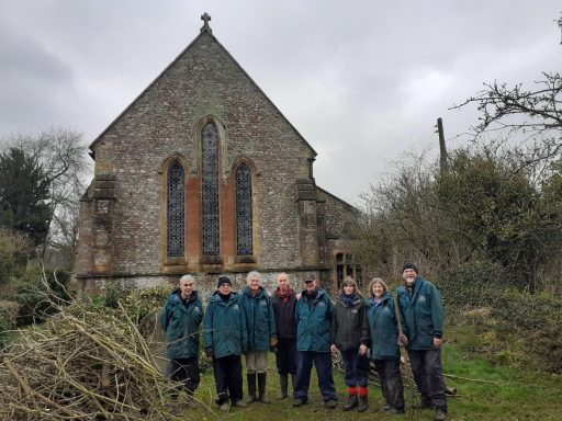 Volunteers at Dunkeswell Abbey men and women stood outside the Abbey