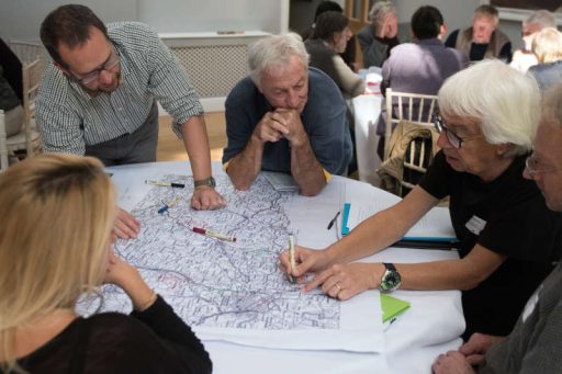 People discussing a map in a workshop