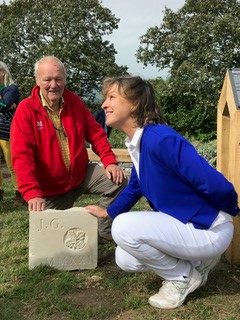 Rebecca Pow presenting John Greenshileds with an engraved stone from the Monument