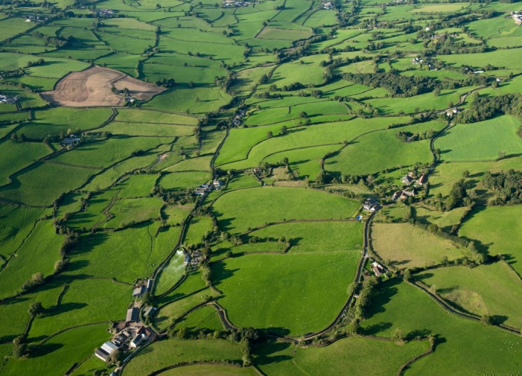 An aerial photograph showing fields and hedgerows and other landscape features.