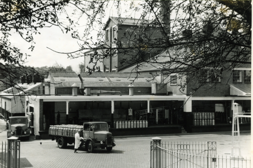 A black and white historic photograph of a mil factory.