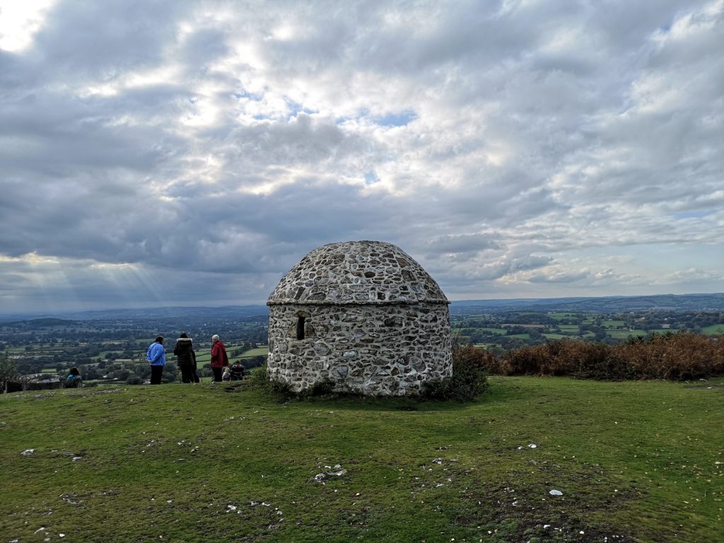 Three people admiring the view next to Culmstock Beacon